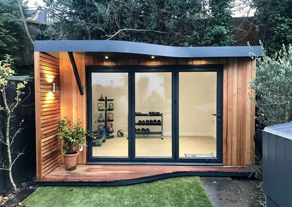 Small, luxury wooden garden studio being used as a garden gym by Divergent Concepts